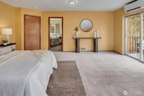 a bedroom with bed and a painting on the wall