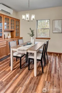 a view of a dining room with furniture window and wooden floor