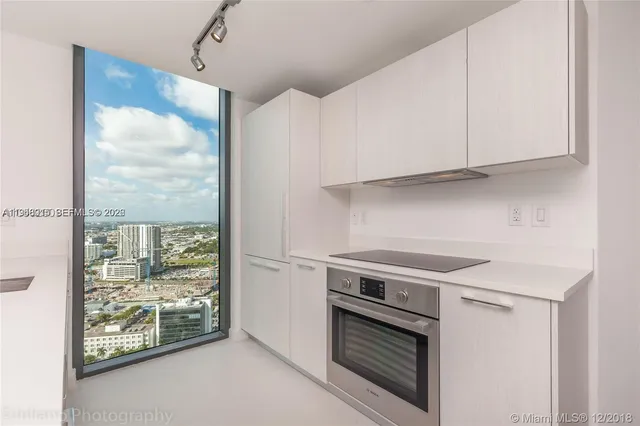 a kitchen with stainless steel appliances granite countertop a stove and a refrigerator