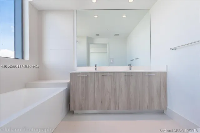 a bathroom with a bathtub a sink and a shower