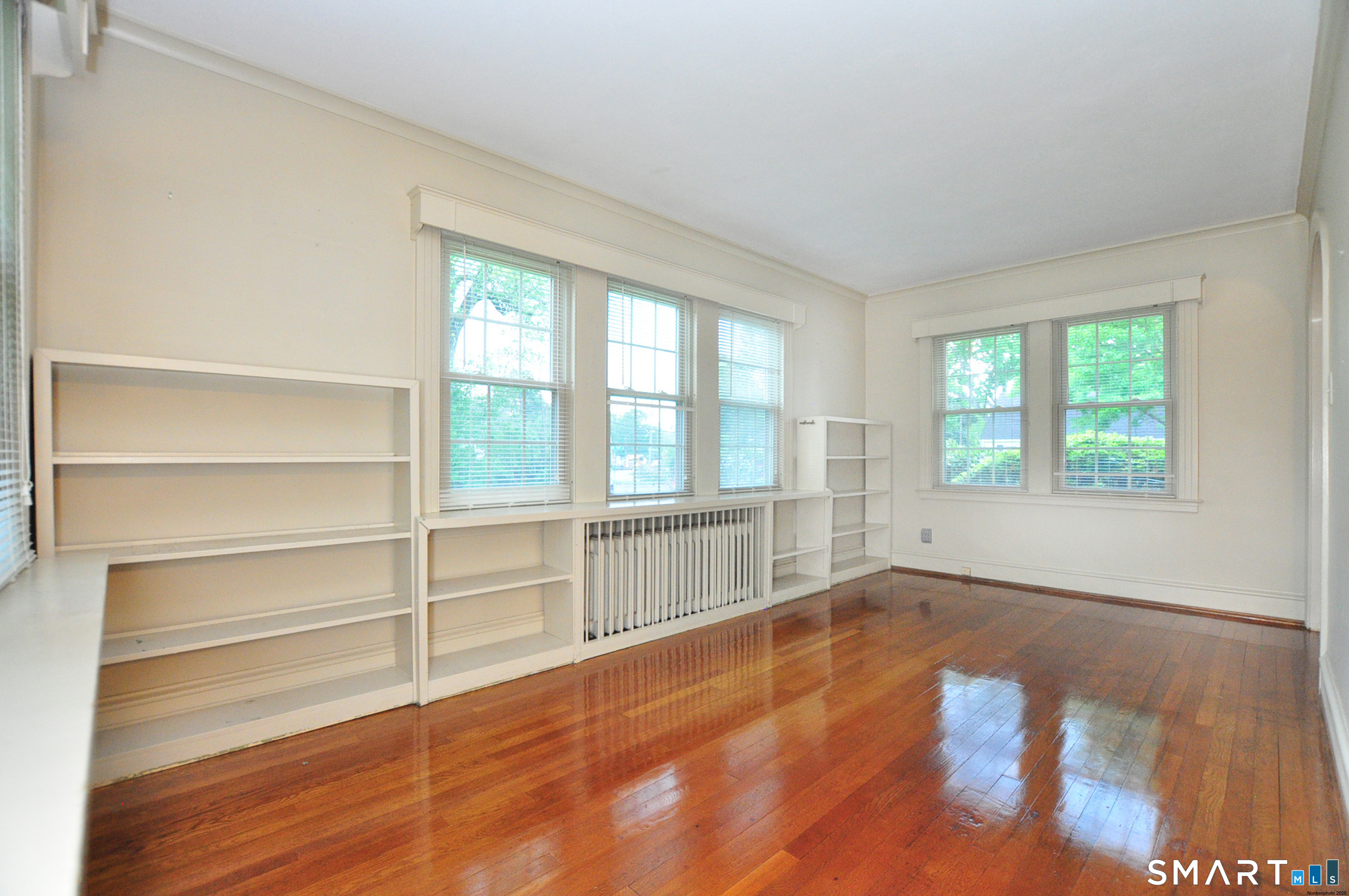10 Harvey Road Windsor, CT 06095 - Photo 7 of 36 a view of an empty room with a window and wooden floor