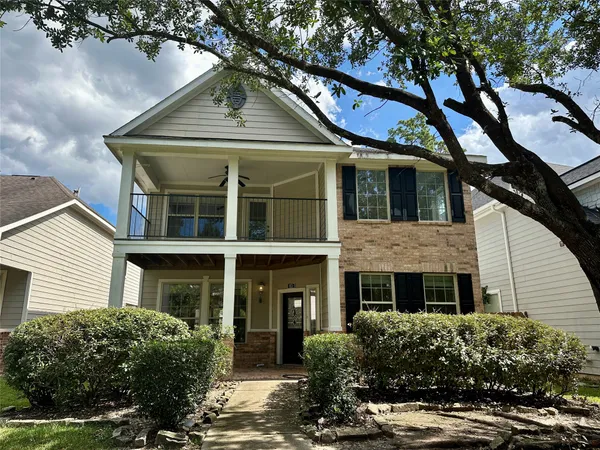 a front view of a house with a yard garage and outdoor seating