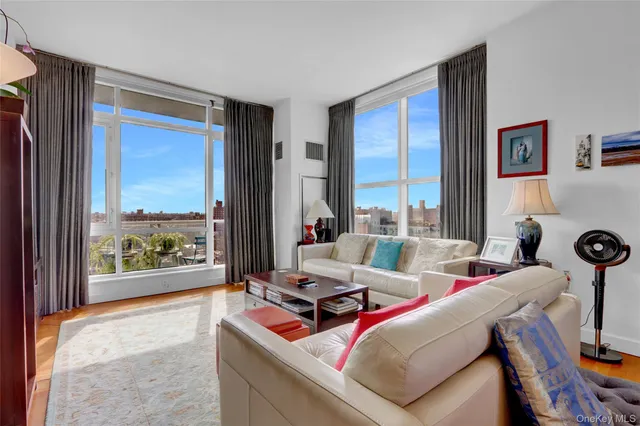a living room with furniture and a floor to ceiling window