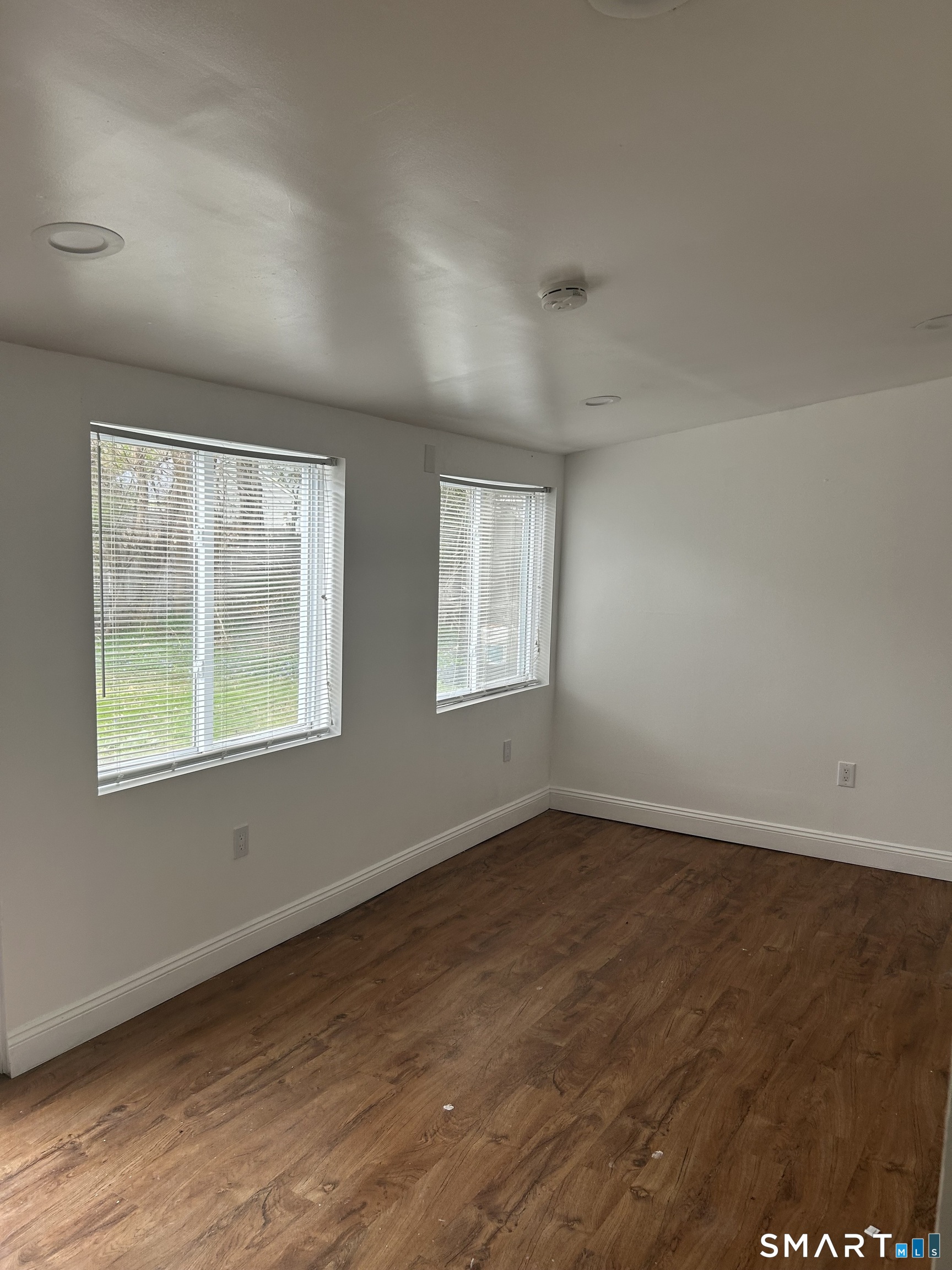 26 Sunnydale Road East Hartford, CT 06118 - Photo 17 of 17 an empty room with wooden floor and windows