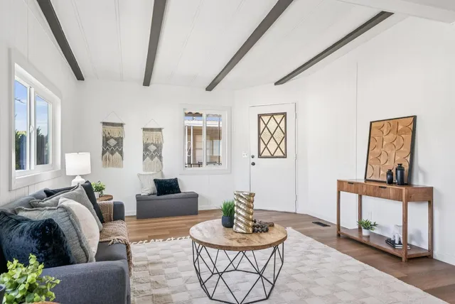 a living room with granite countertop furniture a dining table with kitchen view