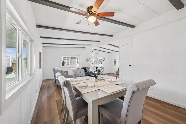 a kitchen with stainless steel appliances granite countertop a sink dishwasher stove and white cabinets