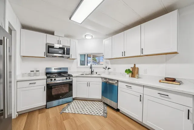 a kitchen with a sink stove and cabinets