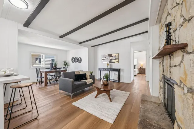 a living room with furniture a fireplace and a table