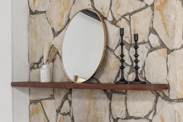 a bedroom with a bed and a dresser next to a window