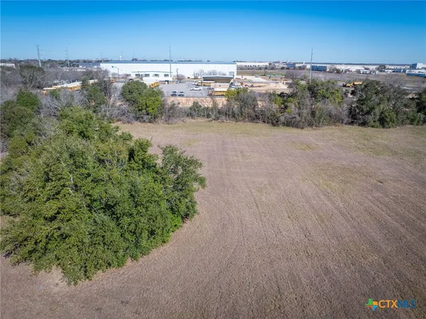 a view of a dry yard with sunset view