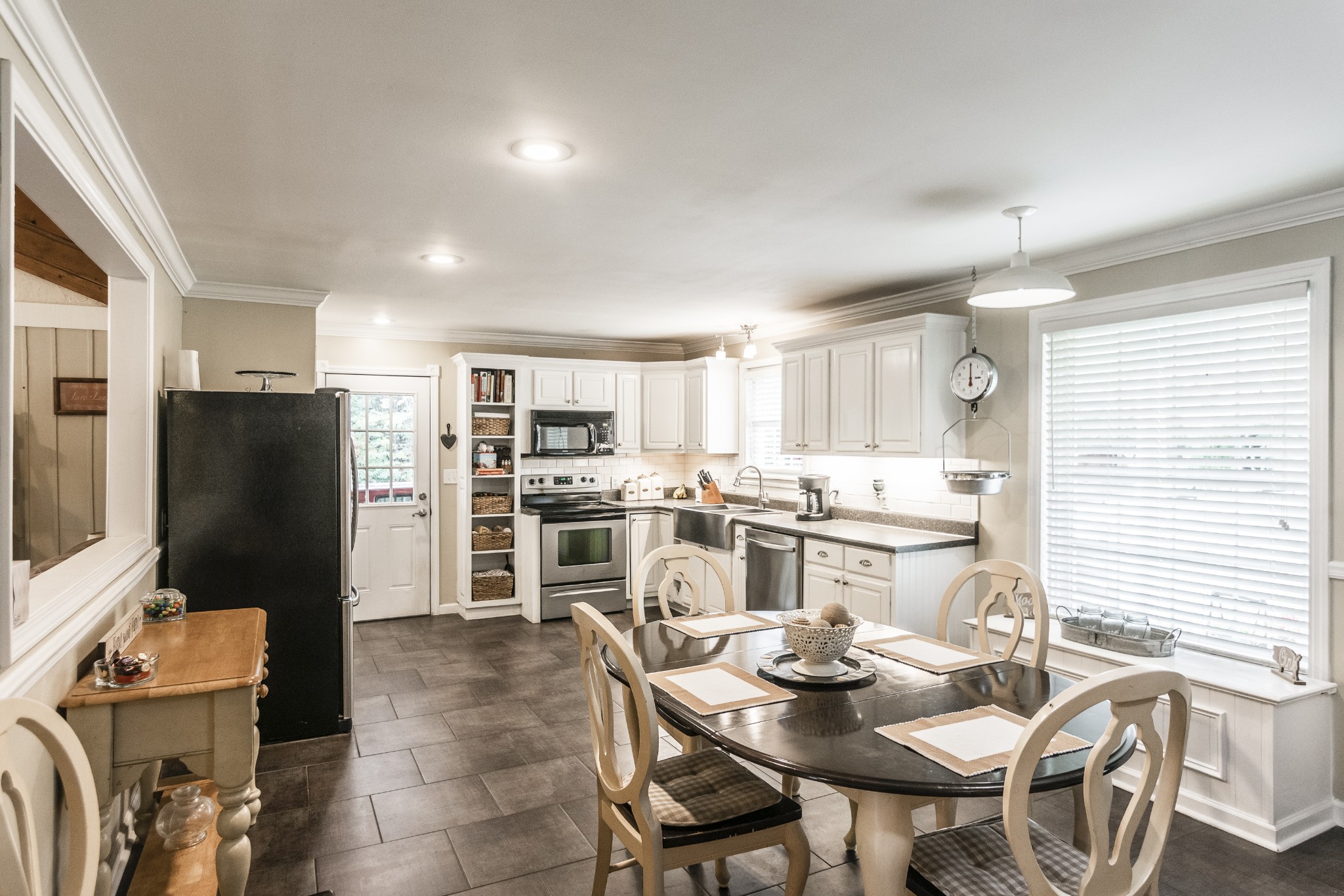 2527 Ewell Elliott Road Springfield, TN 37172 - Photo 28 of 50 a kitchen with stainless steel appliances kitchen island granite countertop a table and chairs in it