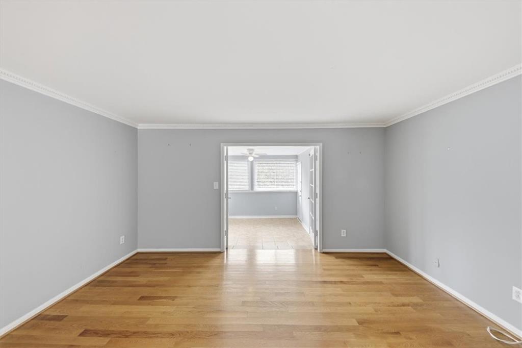 54 La Rue Place Northwest Atlanta, GA 30327 - Photo 11 of 36 a view of an empty room and wooden floor and a window
