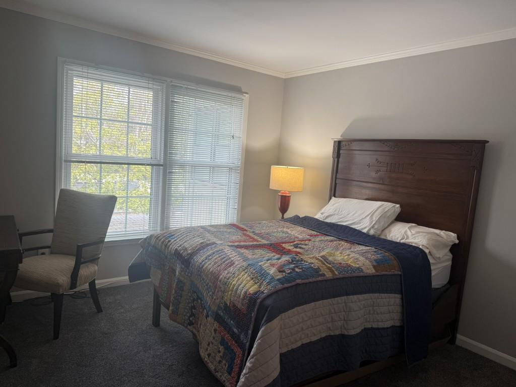 54 La Rue Place Northwest Atlanta, GA 30327 - Photo 12 of 20 a bedroom with a bed chair and window