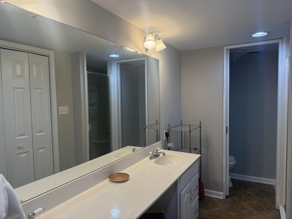 54 La Rue Place Northwest Atlanta, GA 30327 - Photo 15 of 20 a bathroom with a sink a vanity and a mirror