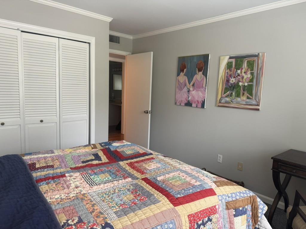 54 La Rue Place Northwest Atlanta, GA 30327 - Photo 17 of 20 a bedroom with a bed and a painting on the wall