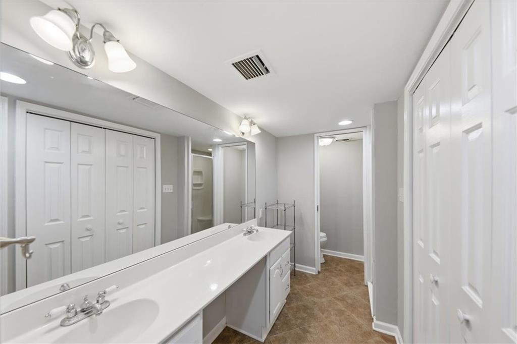 54 La Rue Place Northwest Atlanta, GA 30327 - Photo 24 of 36 a bathroom with a double vanity sink a mirror and a shower