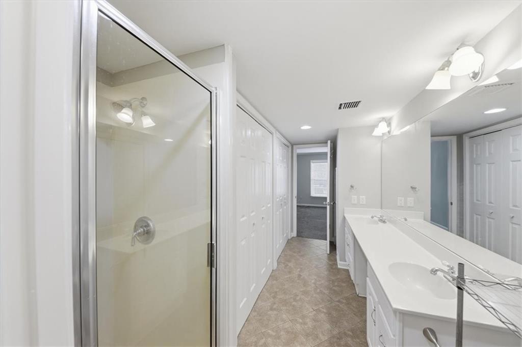 54 La Rue Place Northwest Atlanta, GA 30327 - Photo 25 of 36 a spacious bathroom with a tub shower and a sink