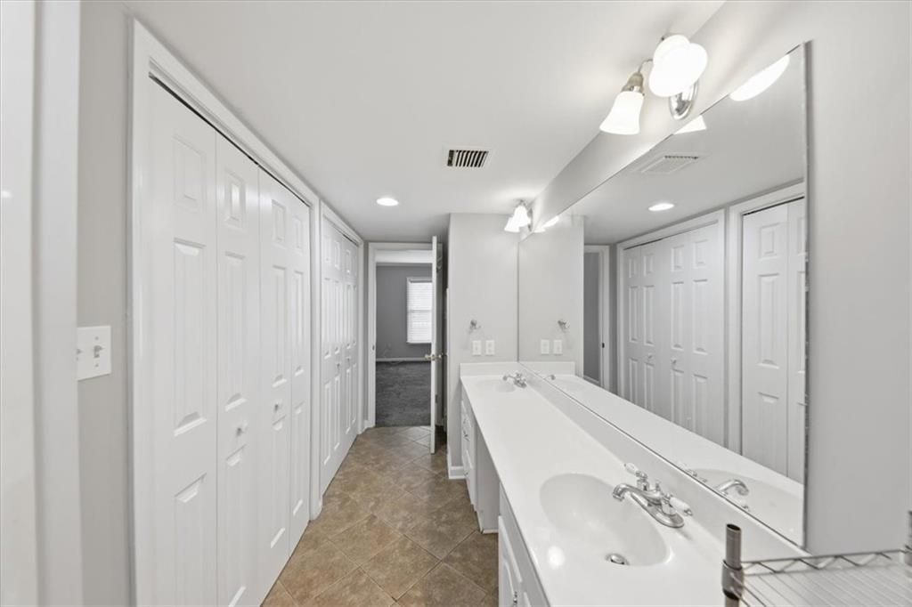 54 La Rue Place Northwest Atlanta, GA 30327 - Photo 26 of 36 a bathroom with a tub sink and mirror
