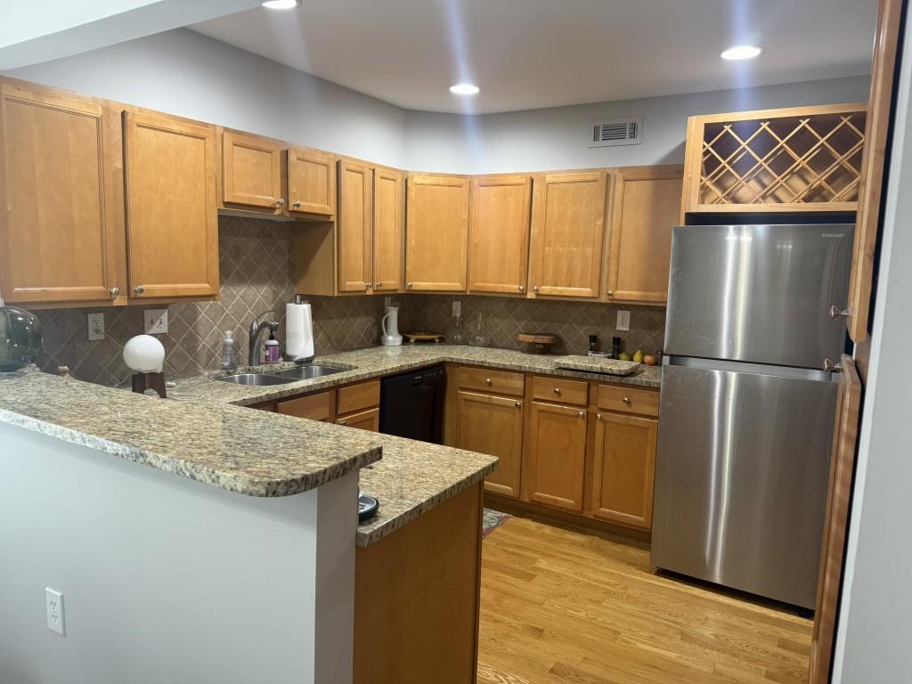 54 La Rue Place Northwest Atlanta, GA 30327 - Photo 3 of 20 a kitchen with a sink a refrigerator and cabinets
