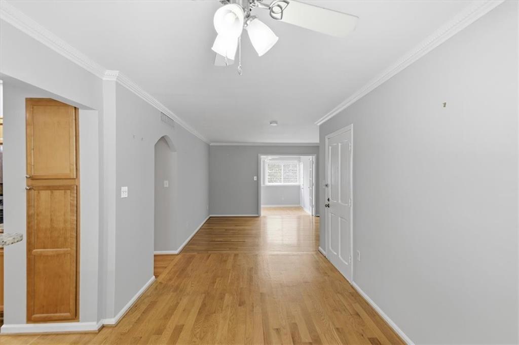 54 La Rue Place Northwest Atlanta, GA 30327 - Photo 3 of 36 a view of a room with wooden floor and a ceiling fan