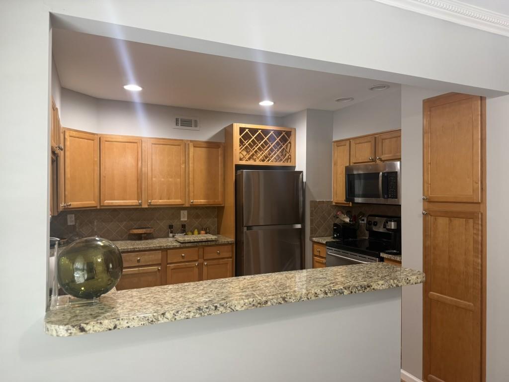 54 La Rue Place Northwest Atlanta, GA 30327 - Photo 4 of 20 a kitchen with granite countertop a refrigerator and a sink