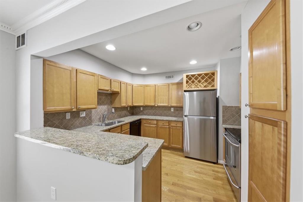 54 La Rue Place Northwest Atlanta, GA 30327 - Photo 5 of 36 a kitchen with a refrigerator and a sink