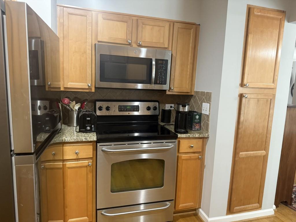 54 La Rue Place Northwest Atlanta, GA 30327 - Photo 5 of 20 a kitchen with a stove and a microwave