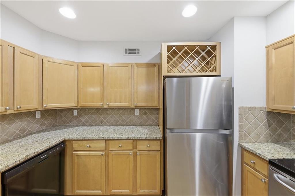 54 La Rue Place Northwest Atlanta, GA 30327 - Photo 9 of 36 a kitchen with stainless steel appliances granite countertop a refrigerator and a sink