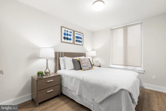 a bedroom with a bed and a window