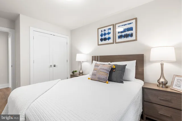 a bedroom with a bed and a lamp on table