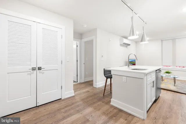 a kitchen with a sink cabinets and wooden floor