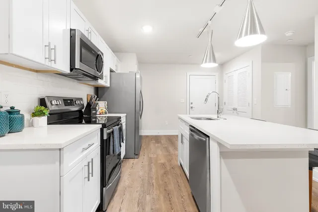 a kitchen with a sink a stove and cabinets