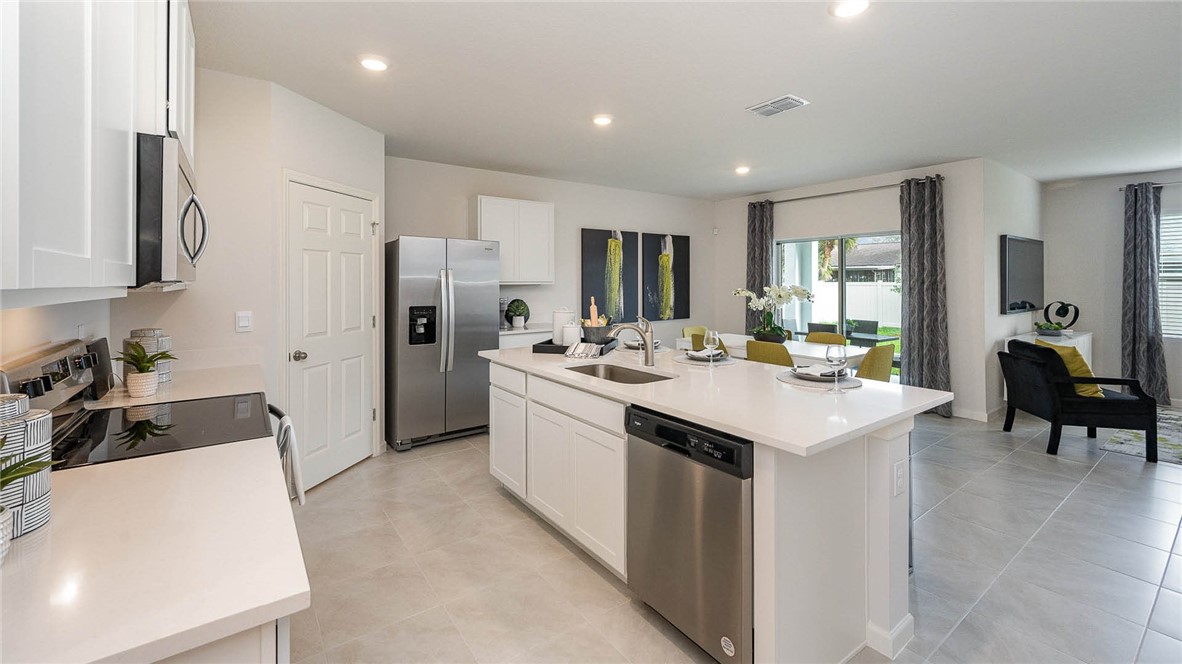 608 Lawson Street Sebastian, FL 32958 - Photo 11 of 30 a kitchen with a sink a counter top space stainless steel appliances cabinets and a window