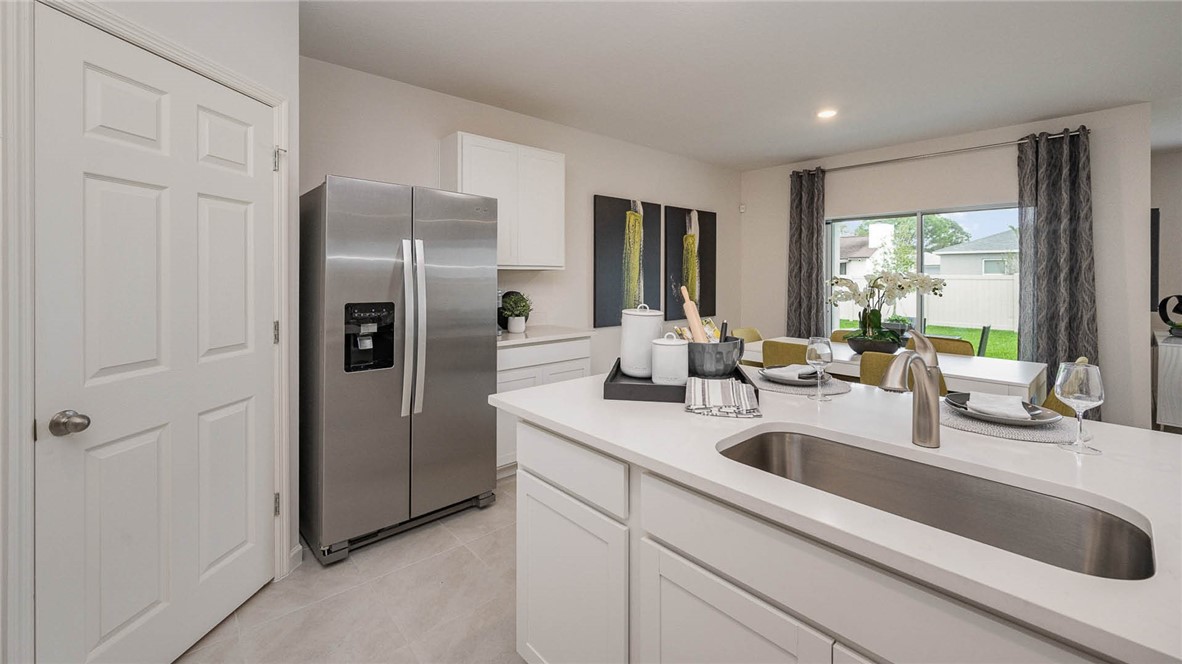 608 Lawson Street Sebastian, FL 32958 - Photo 14 of 30 a kitchen with a sink and refrigerator