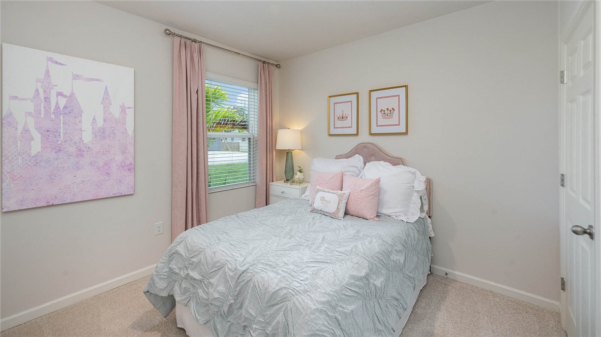 608 Lawson Street Sebastian, FL 32958 - Photo 16 of 30 a bedroom with a bed and a window