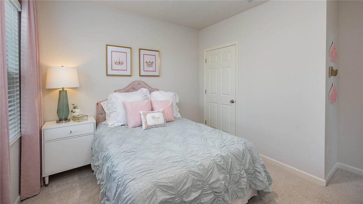 608 Lawson Street Sebastian, FL 32958 - Photo 17 of 30 a bed room with a bed and a white wall