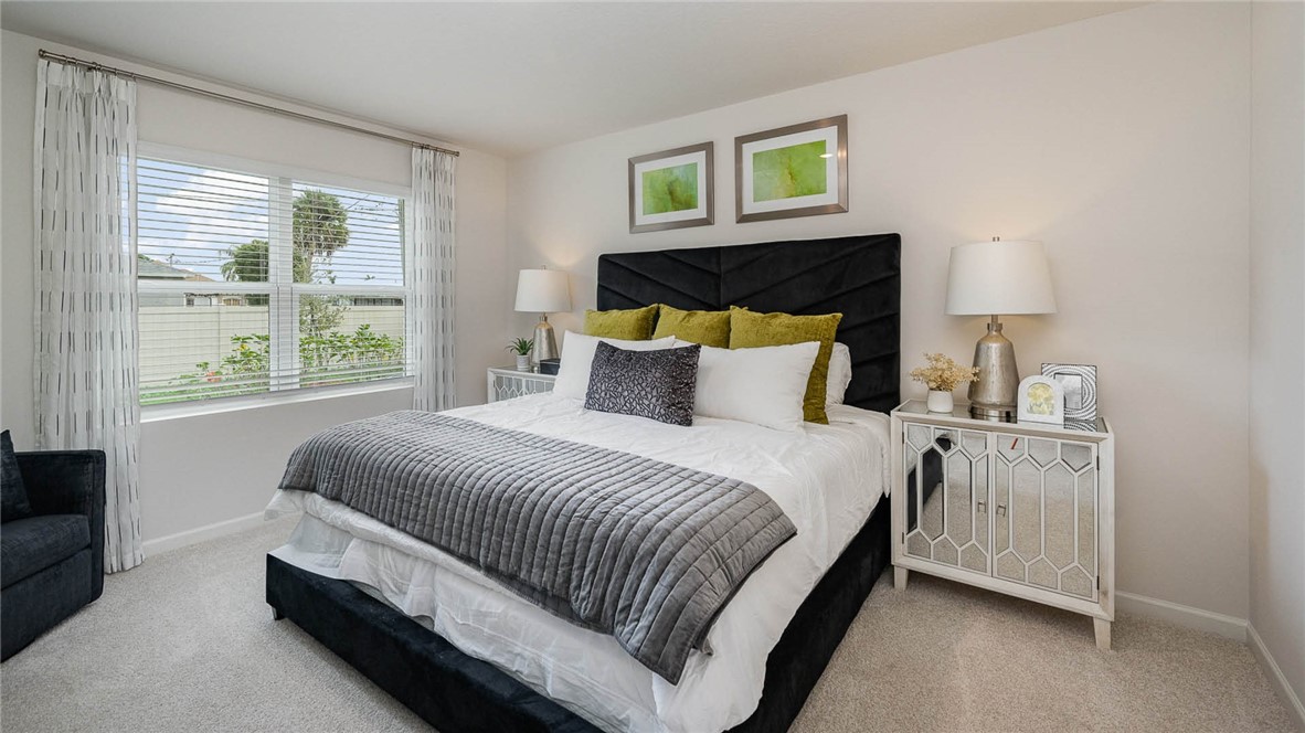 608 Lawson Street Sebastian, FL 32958 - Photo 18 of 30 a bedroom with a bed and a window