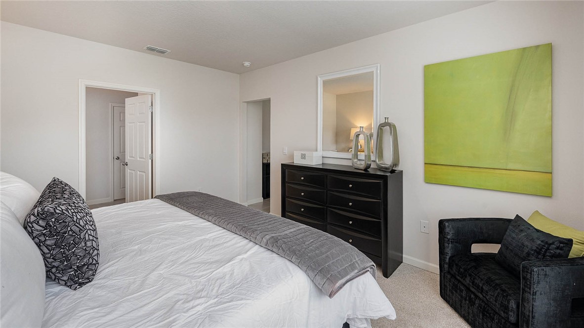 608 Lawson Street Sebastian, FL 32958 - Photo 19 of 30 a bedroom with a bed and a dresser