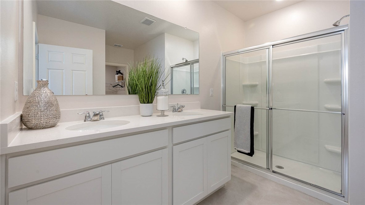 608 Lawson Street Sebastian, FL 32958 - Photo 20 of 30 a bathroom with a double vanity sink mirror and shower