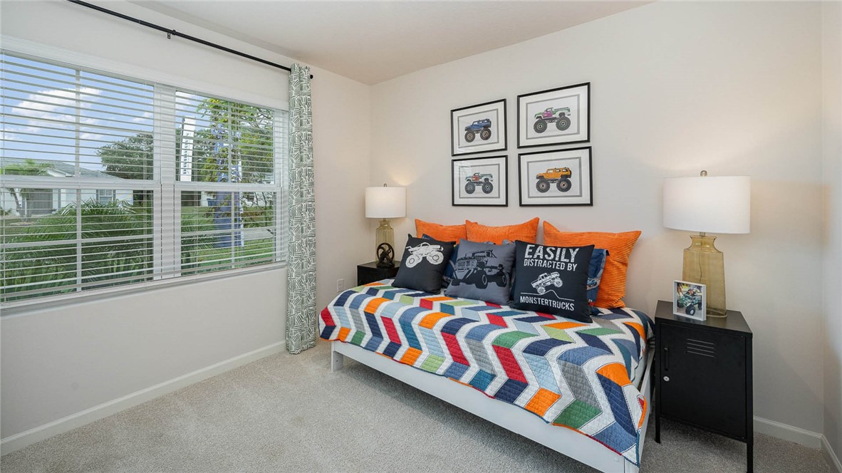 608 Lawson Street Sebastian, FL 32958 - Photo 3 of 30 a bedroom with a bed and a painting on the wall