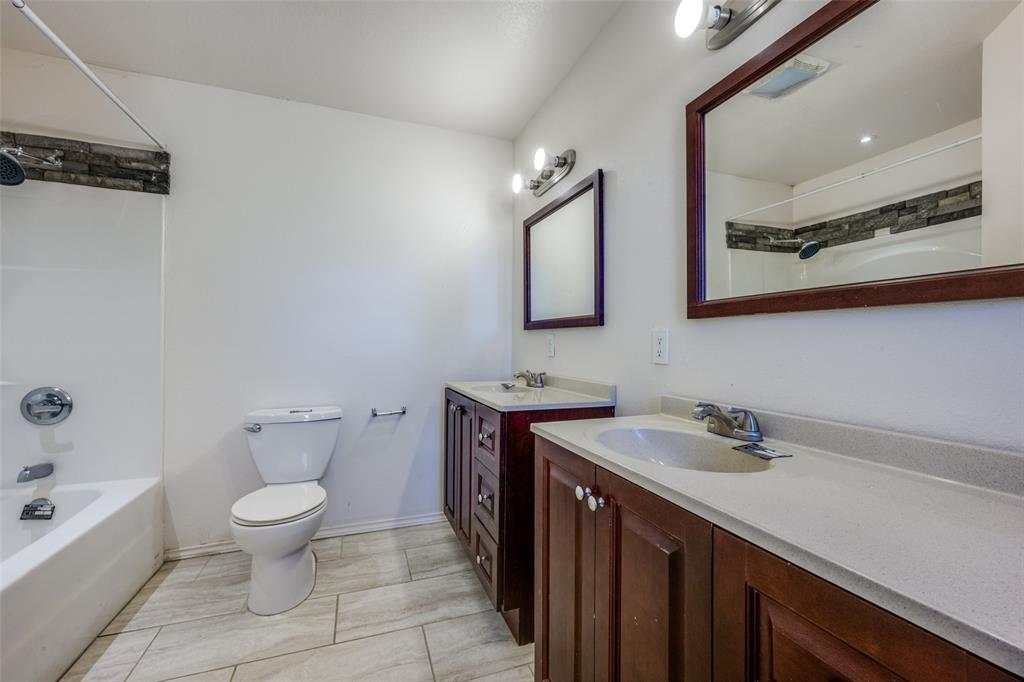 970 McReynolds Road Sanger, TX 76266 - Photo 11 of 25 a bathroom with a sink a toilet and mirror