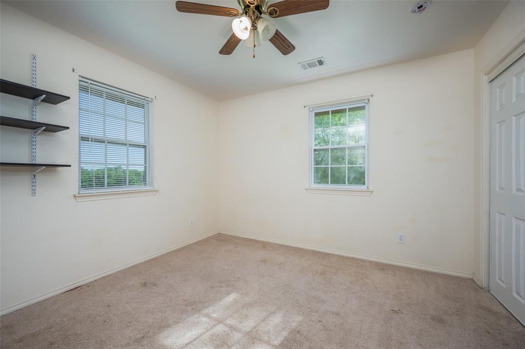 970 McReynolds Road Sanger, TX 76266 - Photo 12 of 25 an empty room with a window and a ceiling fan