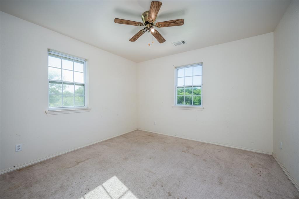 970 McReynolds Road Sanger, TX 76266 - Photo 13 of 25 an empty room with windows and fan