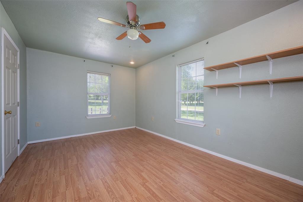 970 McReynolds Road Sanger, TX 76266 - Photo 21 of 25 a view of an empty room with a window and wooden floor