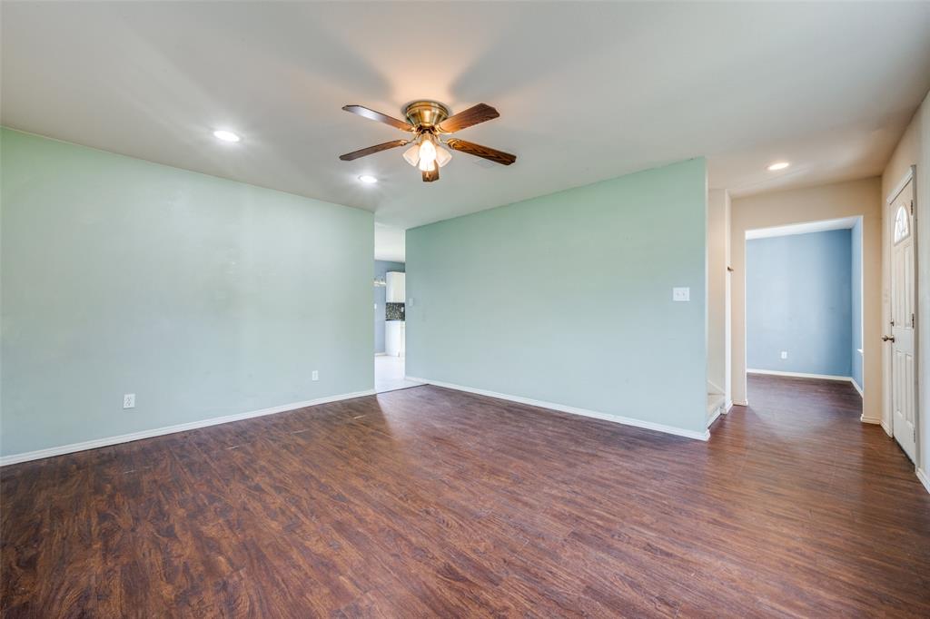 970 McReynolds Road Sanger, TX 76266 - Photo 3 of 25 a view of an empty room with wooden floor and a ceiling fan