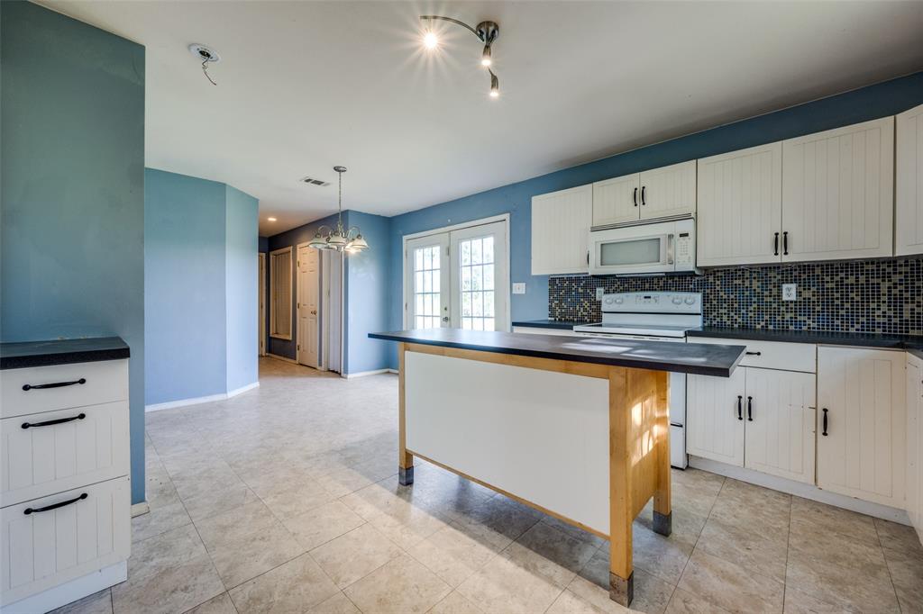 970 McReynolds Road Sanger, TX 76266 - Photo 6 of 25 a large kitchen with stainless steel appliances granite countertop a stove a sink and a refrigerator