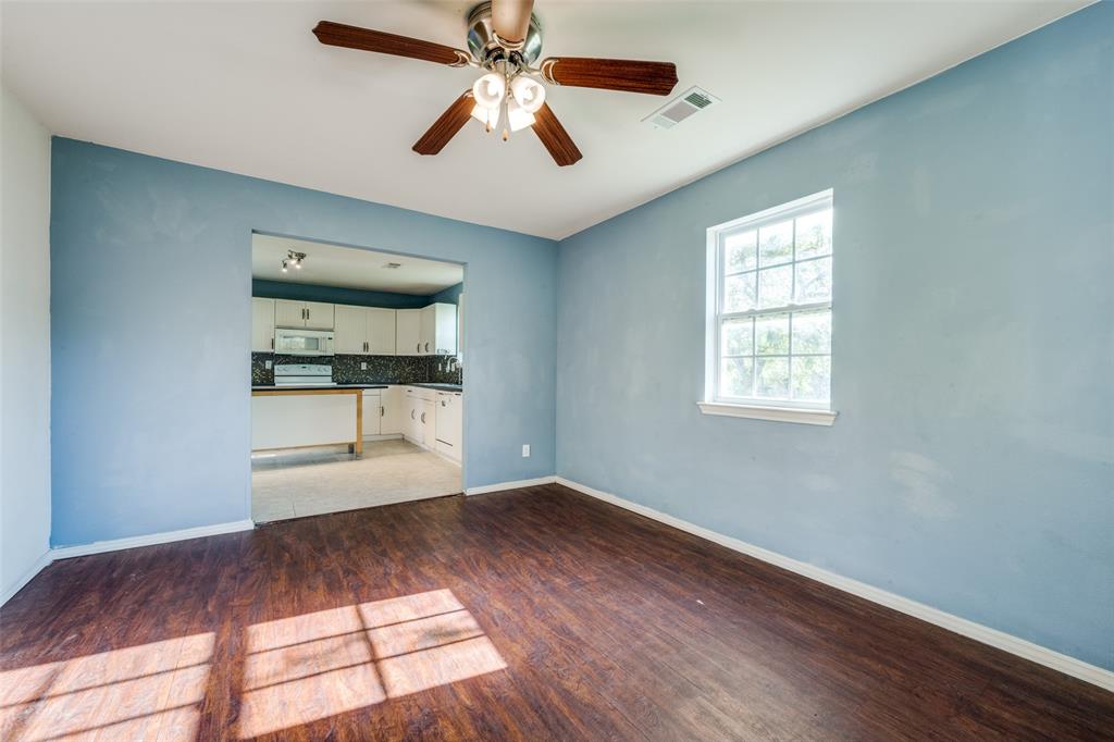 970 McReynolds Road Sanger, TX 76266 - Photo 7 of 25 an empty room with wooden floor fan and windows