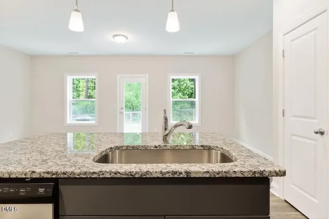 a view of bathroom with granite countertop bathtub