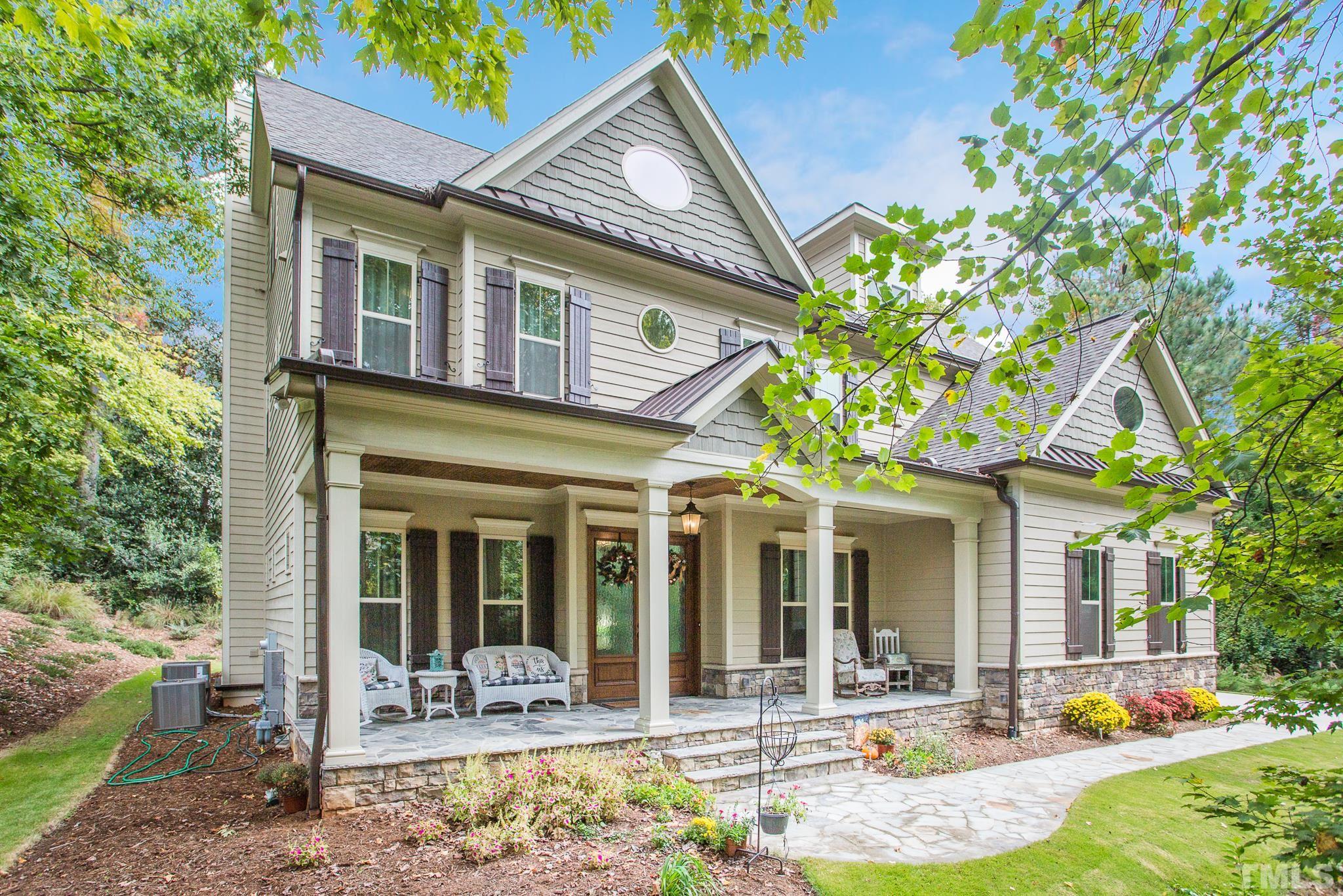 a front view of a house with outdoor seating