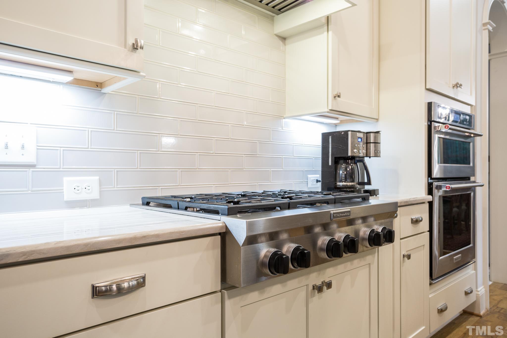 1921 Banbury Road Raleigh, NC 27608 - Photo 13 of 30 a stove top oven sitting inside of a kitchen